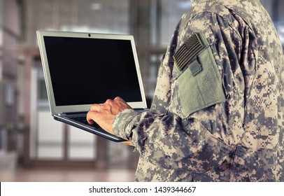 Young Military Soldier Man Portrait With Laptop On  Background