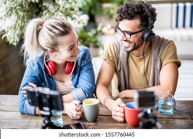 Young Millenial Couple Sharing Creative Content Online On Webcam - Digital Marketing Concept With Next Generation Influencer Having Fun On Radio Video Stream - Vlogging Time At Startup Coworking Space