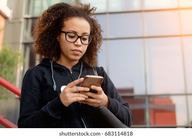 Young Millenial Girl Texting On Her Mobile Phone