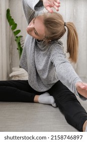 Young Millennial Blonde Woman Doing Yoga Exercise Stretching Fitness At Balcony Home. Mindfulness Meditation. Relax Breathe Easy Pose Gym Healthy Lifestyle Concept.