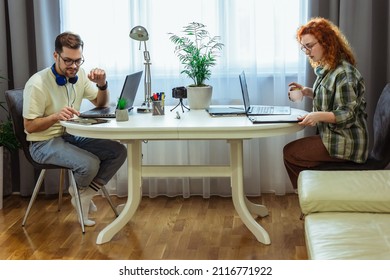 Young Millennial Couple Working At Home. Concept Of Freelance And Remote Work