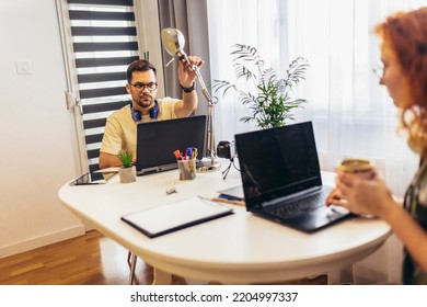 Young Millennial Couple Working At Home. Concept Of Freelance And Remote Work