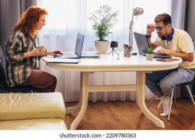 Young Millennial Couple Working At Home. Concept Of Freelance And Remote Work. Selective Focus.