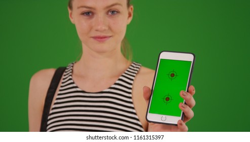 Young Millennial Girl Holding Phone With Green Screen On Display On Green Screen