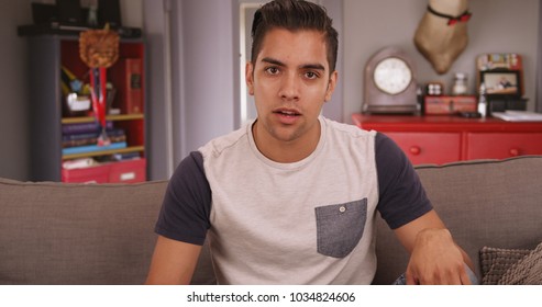 Young millennial Hispanic man talking to camera