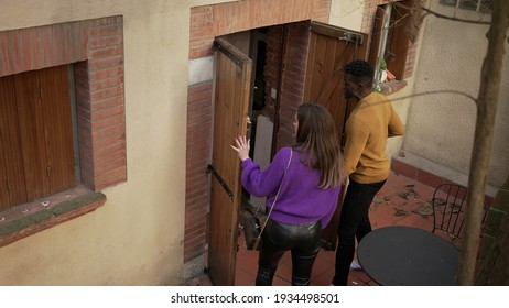 Young millennial interracial couple arriving home opening front door and entering house - Powered by Shutterstock