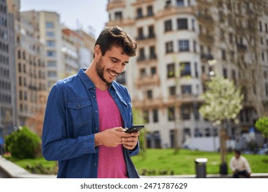 young millennial walking in the city looking at her smart phone while walking - Powered by Shutterstock