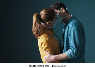 Young Millennials Couple Wearing Protective Face Masks And Kissing Each Other, Virus Spread Prevention And People Concept