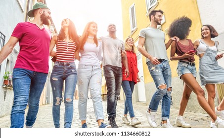 Young millennials friends walking in city old town center - Happy people having fun together - Youth lifestyle, generation z and friendship concept - Main focus on left girl face - Shutterstock ID 1134660812