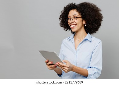 Young minded happy employee business corporate lawyer woman of African American ethnicity in classic formal shirt work in office hold use tablet pc computer isolated on grey color background studio - Powered by Shutterstock
