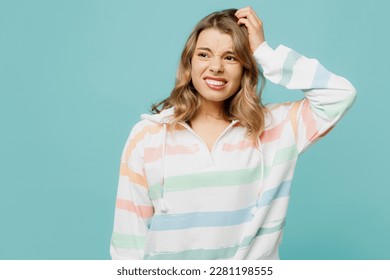 Young mistaken troubled confused sad dissatisfied blonde woman wear hoody look aside hold scratch head say oops isolated on plain pastel light blue cyan background studio portrait Lifestyle concept - Shutterstock ID 2281198555