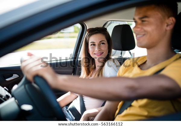 Young\
mixed ethnic couple together in car - man\
driving