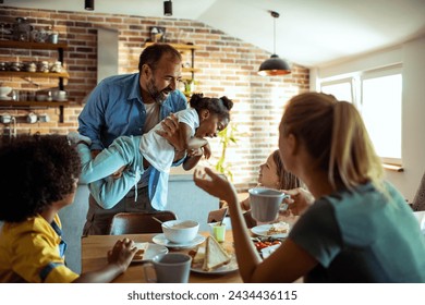 Young mixed family eating together at home - Powered by Shutterstock