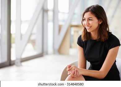 Young mixed race Asian businesswoman looking away