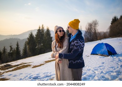 Young Mixed Race Couple Having Fun On The Snow On Winter Vacation