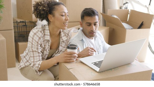 Young Mixed Race Couple Using Laptop