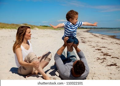 Young Mixed Race Family Having Fun On Their Summer Vacation Outdoors