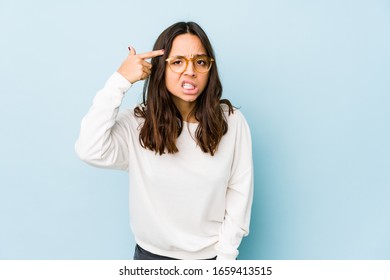 Young mixed race hispanic woman isolated showing a disappointment gesture with forefinger.