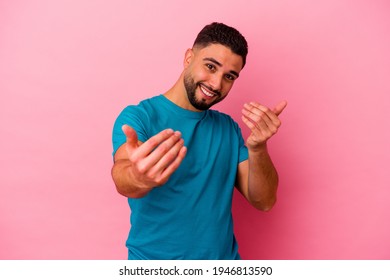 Young Mixed Race Man Isolated On Pink Background Pointing With Finger At You As If Inviting Come Closer.