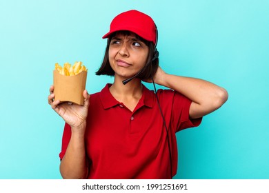 Young Mixed Race Woman Fast Food Restaurant Worker Holding Fries Isolated On Blue Background Touching Back Of Head, Thinking And Making A Choice.