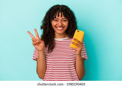 Young Mixed Race Woman Holding A Mobile Phone Isolated On Blue Background Showing Number Two With Fingers.