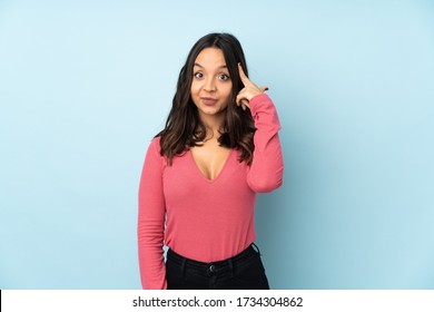 Young mixed race woman isolated on blue background thinking an idea - Shutterstock ID 1734304862