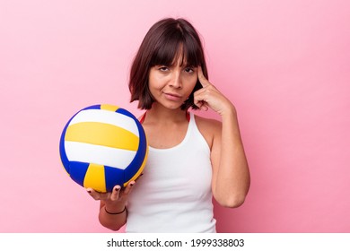 Young Mixed Race Woman Playing Volleyball Isolated On Pink Background Pointing Temple With Finger, Thinking, Focused On A Task.