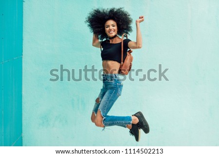 Similar – Young mixed woman with afro hair jumping outdoors.