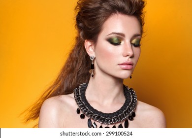 Young Model With Big Lips And Make Up, Smoky Eyes, Brunette, Black Background Fashion Look. Jewelry.