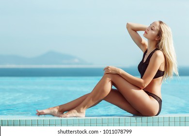 Young Model Girl In Black Bikini Posing Near Pool