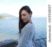 young model posing in a park close to  the lake