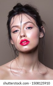 Young Model With Professional Makeup, Perfect Skin, Wet Hairdo. Glossy Eyelids And Glossy Red Lips.