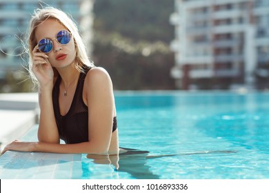 Young Model Woman In Black Bikini In A Swimming Pool