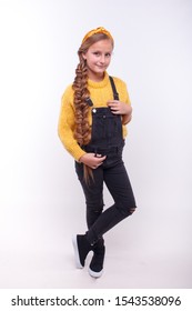 Young Model In A Yellow Sweater And Black Overalls