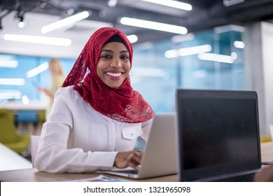 Young Modern Black Muslim Business Woman Wearing A Red Hijab,working On Laptop Computer In Startup Office. Diversity, Multiracial Concept