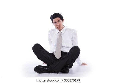 Young and modern businessman relaxing on the floor (isolated on white)