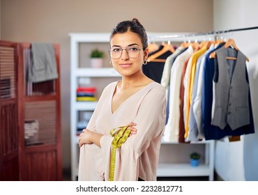 Young Modern Confident smiling Indian Asian woman or female working professional fashion designer is standing in the studio or workplace looking at the camera. women empowerment, job, Ambition concept - Powered by Shutterstock
