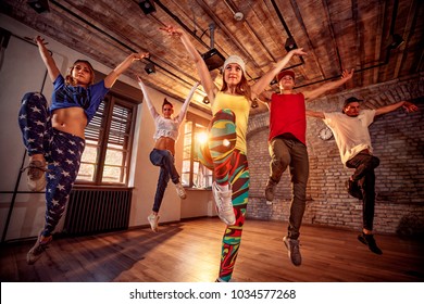 Young modern dancing group practice dancing in jump. Sport, dancing and urban culture concept