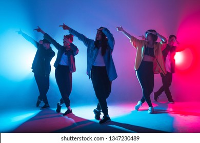 Young modern dancing group of six adult young people practice dancing on colorful background - Powered by Shutterstock