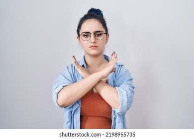 Young Modern Girl With Blue Hair Standing Over White Background Rejection Expression Crossing Arms Doing Negative Sign, Angry Face 