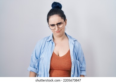 Young Modern Girl With Blue Hair Standing Over White Background Depressed And Worry For Distress, Crying Angry And Afraid. Sad Expression. 