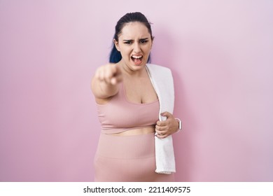 Young Modern Girl With Blue Hair Wearing Sportswear Over Pink Background Pointing Displeased And Frustrated To The Camera, Angry And Furious With You 