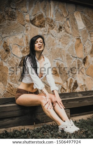 Similar – Beautiful young photographer woman wearing black clothes, sitting on the floor in countryside with her camera