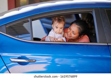 Young Mom With Baby Girl In Car Open Window