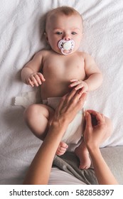 Young Mom Is Changing Her Cute Baby Diaper