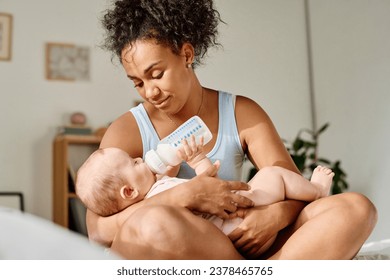 Young mom feeding her baby - Powered by Shutterstock