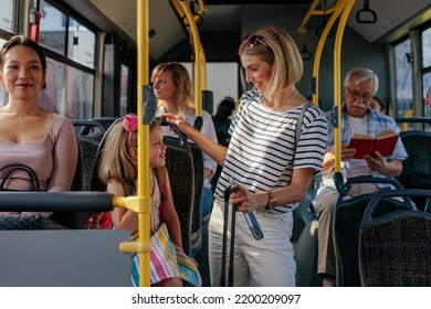 A Young Mom And Her Daughter Are Riding On The Airport Shuttle Bus As They're Preparing To Go For A Travel.