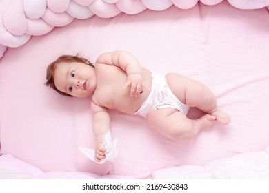 Young Mom Wiping The Baby Skin Body And Face With Wet Wipes Carefully On Pink Background. Concept Cleaning Wipe, Pure, Clean.