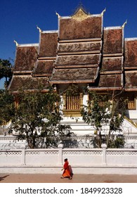 Young Monks Walking Next To A Temple In Luang Prabang - Laos