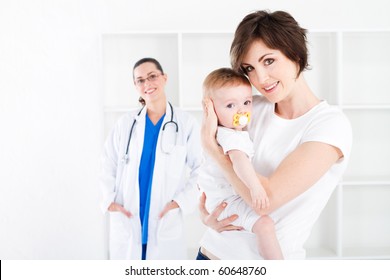 Young Mother And Baby Girl In Doctor Office